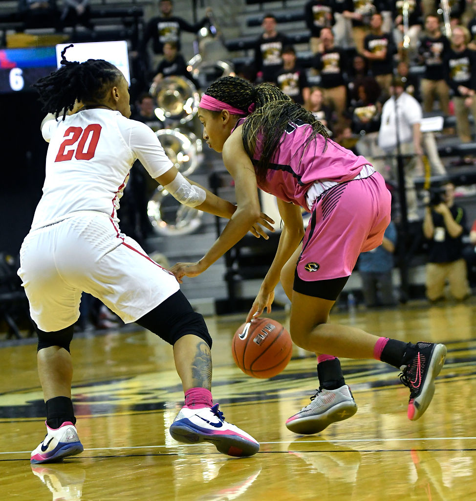 Elle Brown works to dribble around Ole Miss's Jayla Alexander